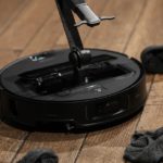 This robovac has an arm that can pick up your dirty laundry